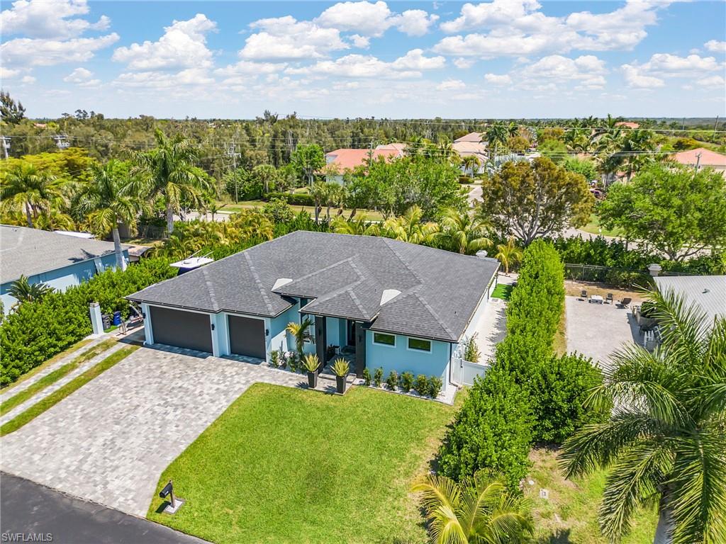 Single-story residence featuring a dark shingle roof and light blue exterior siding