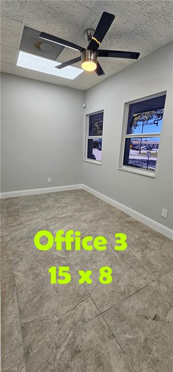 Recessed lighting, ceiling fan with light fixture, two windows, textured ceiling, and tile flooring
