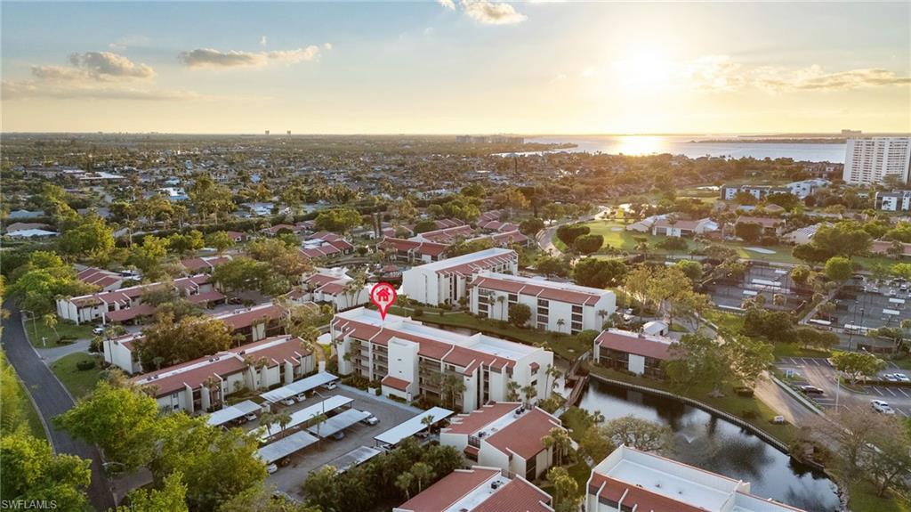 Aerial view at dusk featuring a water view