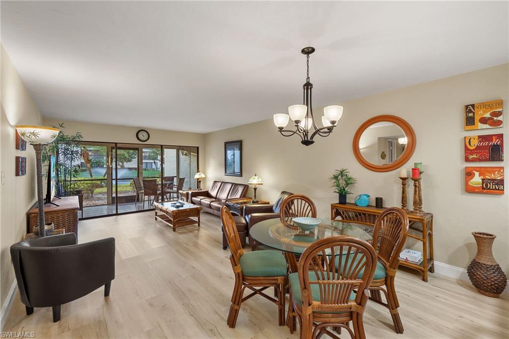 Dining area with light hardwood / wood-style flooring and an inviting chandelier
