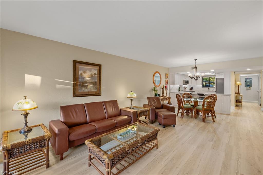 Living room featuring light hardwood / wood-style floors and an inviting chandelier