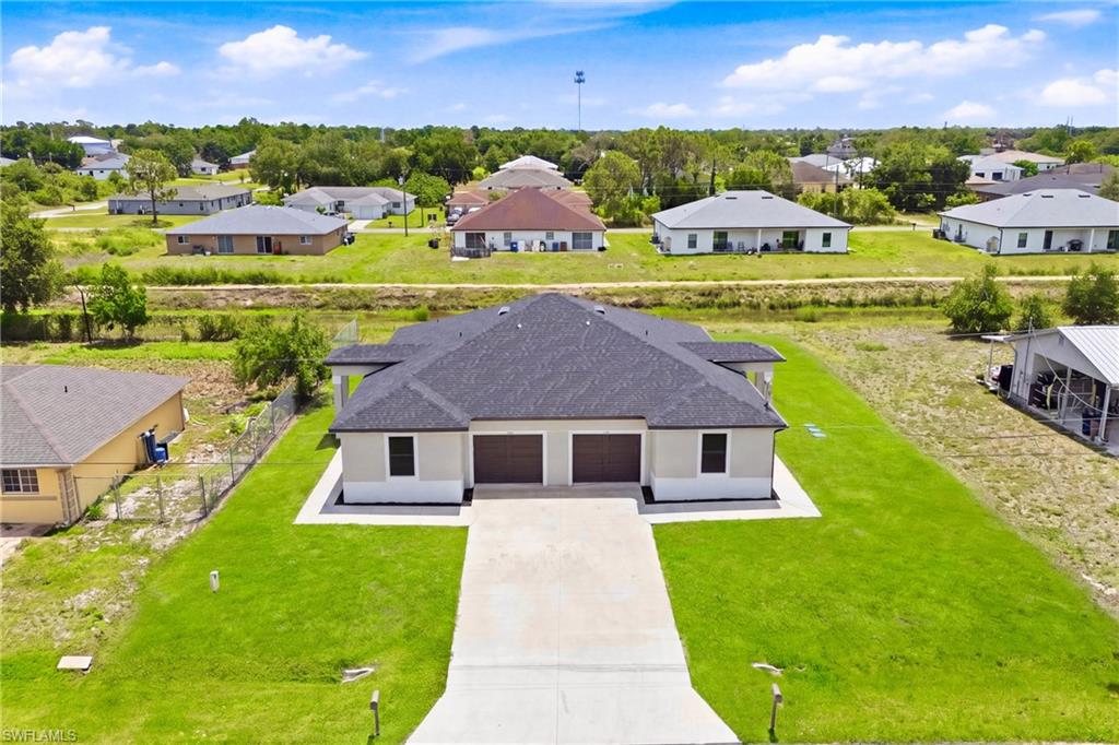 Stunning aerial view showcasing the modern duplex design with peaceful canal backdrop.