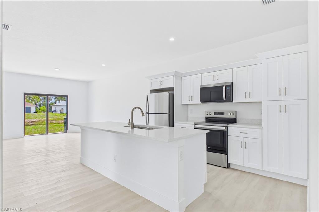 Bright, open kitchen overlooking the spacious living area.