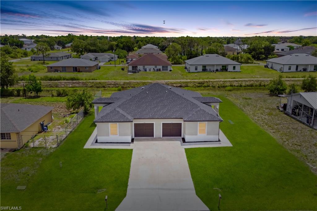 Stunning aerial view showcasing the modern duplex design with peaceful canal backdrop.
