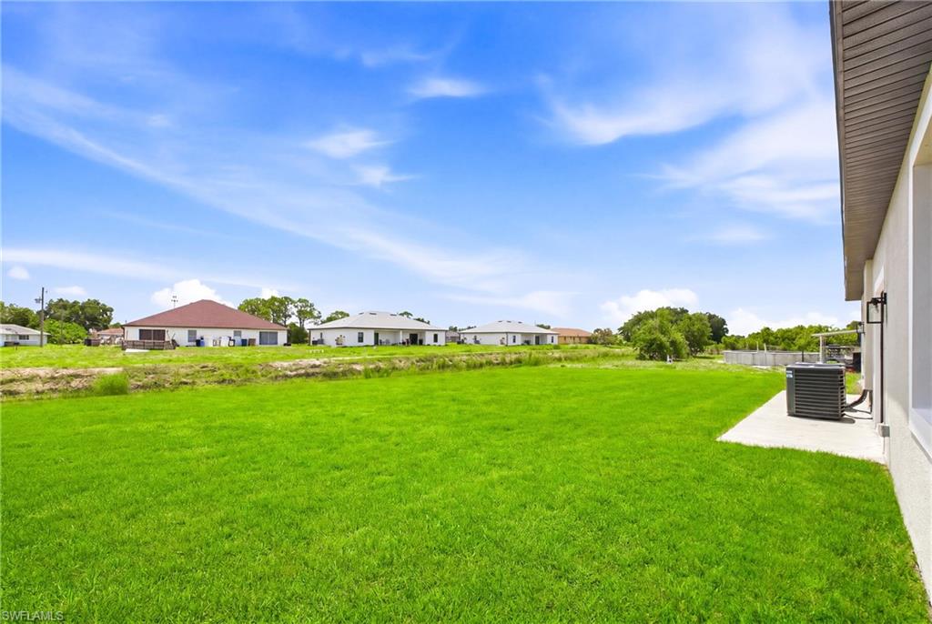 Rear elevation view of the duplex with serene water and nature views.