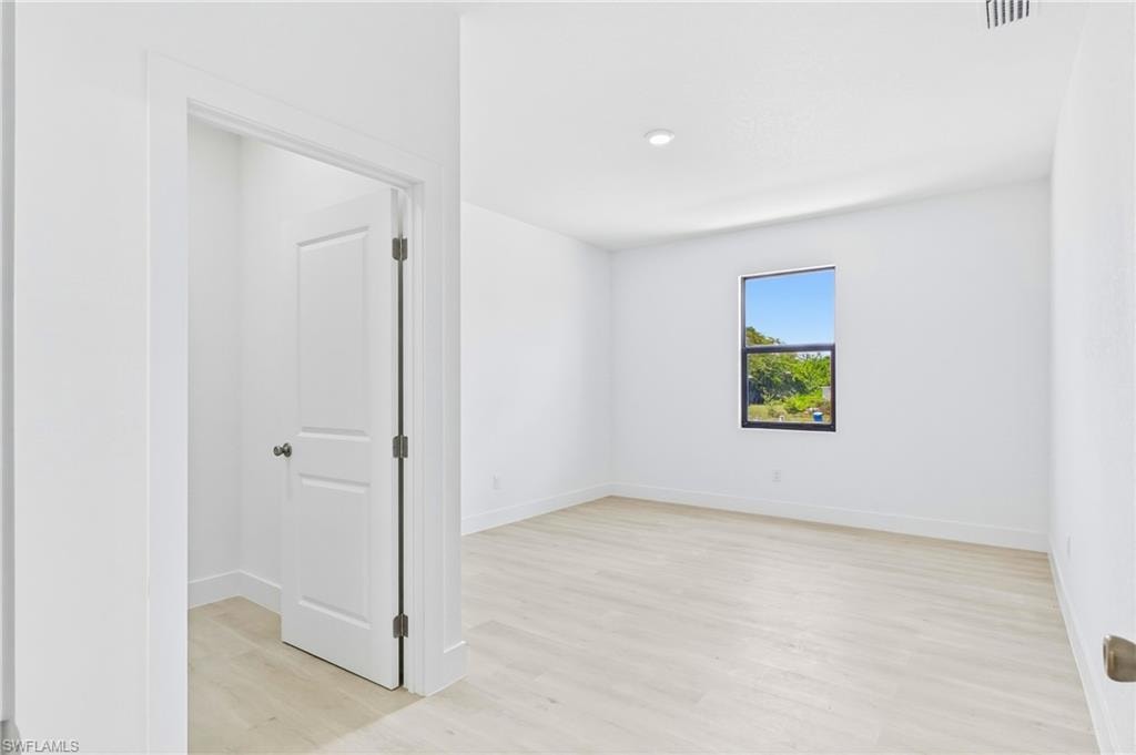 Large primary bedroom filled with natural light and modern elegance.