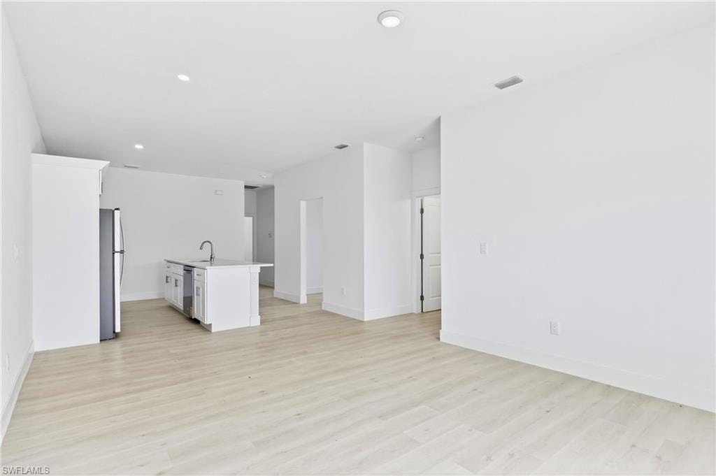Bright and spacious living room flowing seamlessly into the stylish kitchen.
