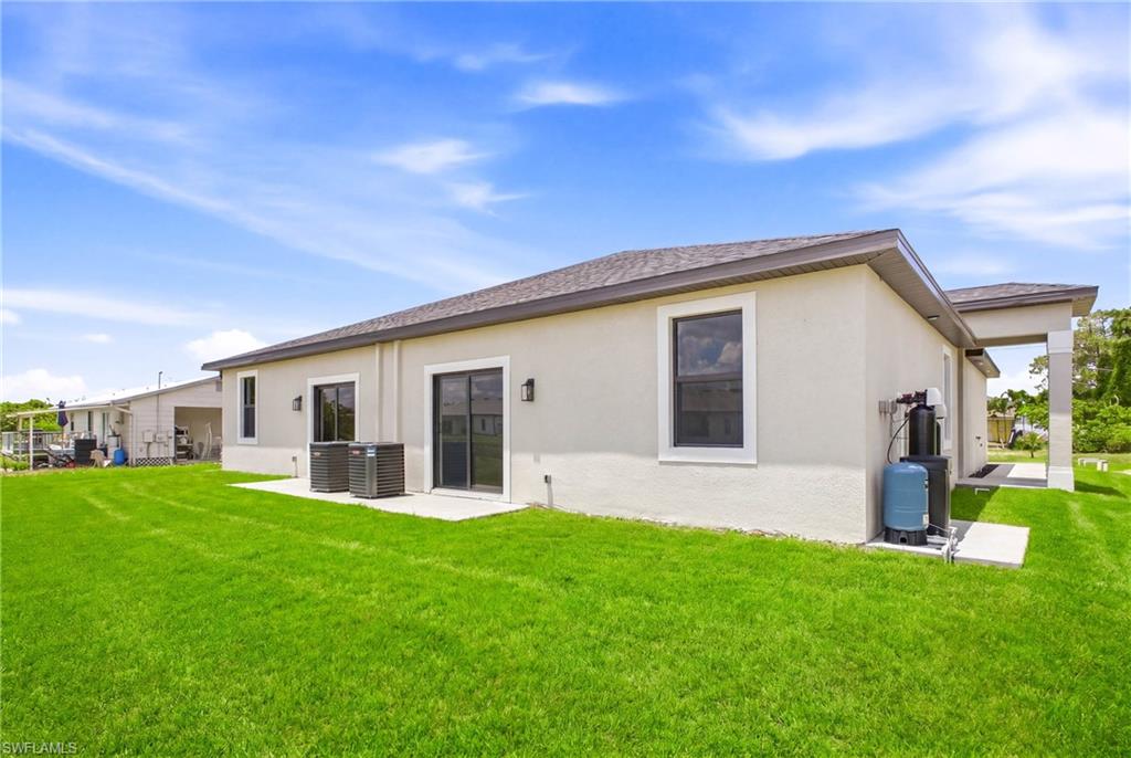 Beautiful backyard scene capturing both residences in a private setting.