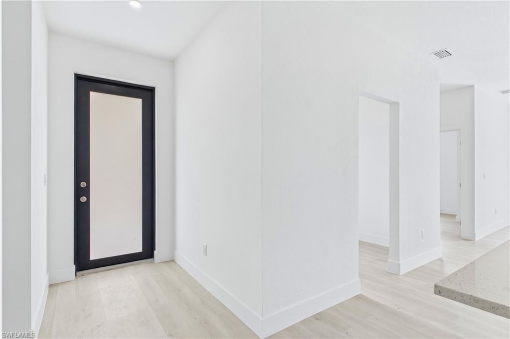 Grand entryway opening to a bright and airy floor plan.