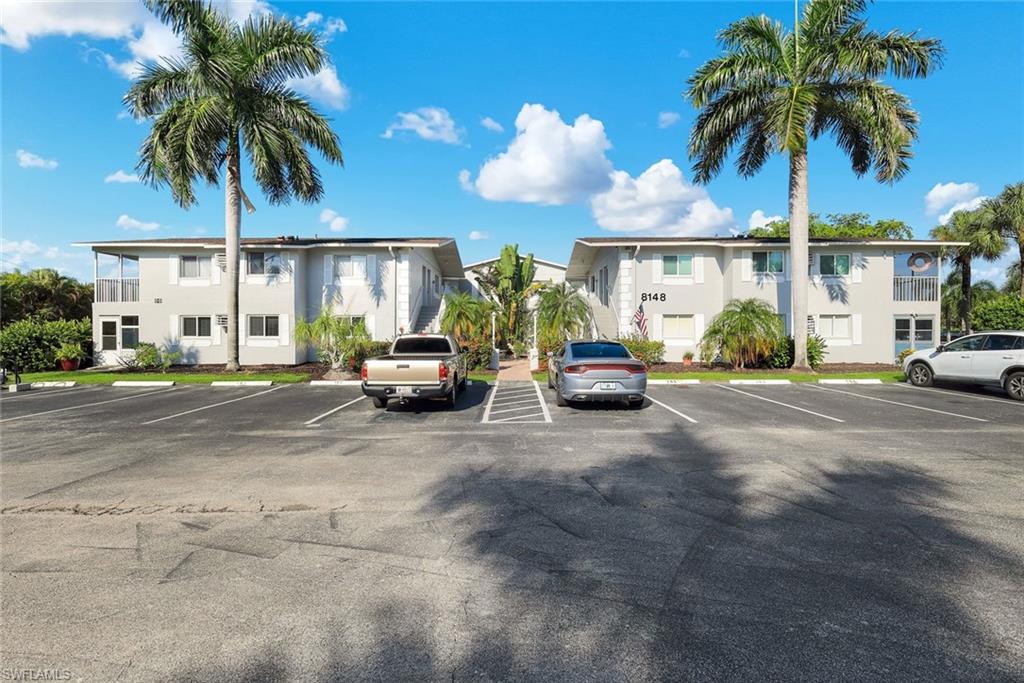 Two-story multifamily structure with exterior balconies, multiple windows, and exterior stair access