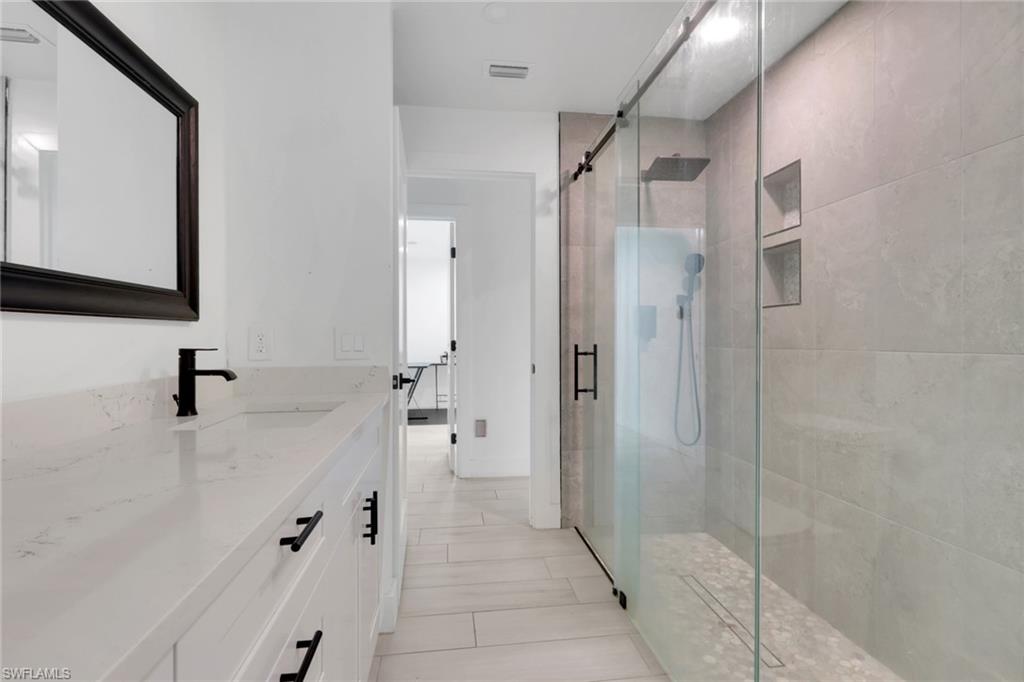 Contemporary bathroom featuring a spacious vanity with a white countertop and undermount sink
