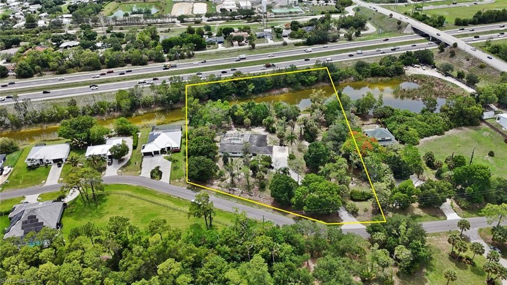 Expansive property featuring mature trees, a private driveway, and direct frontage on a natural pond