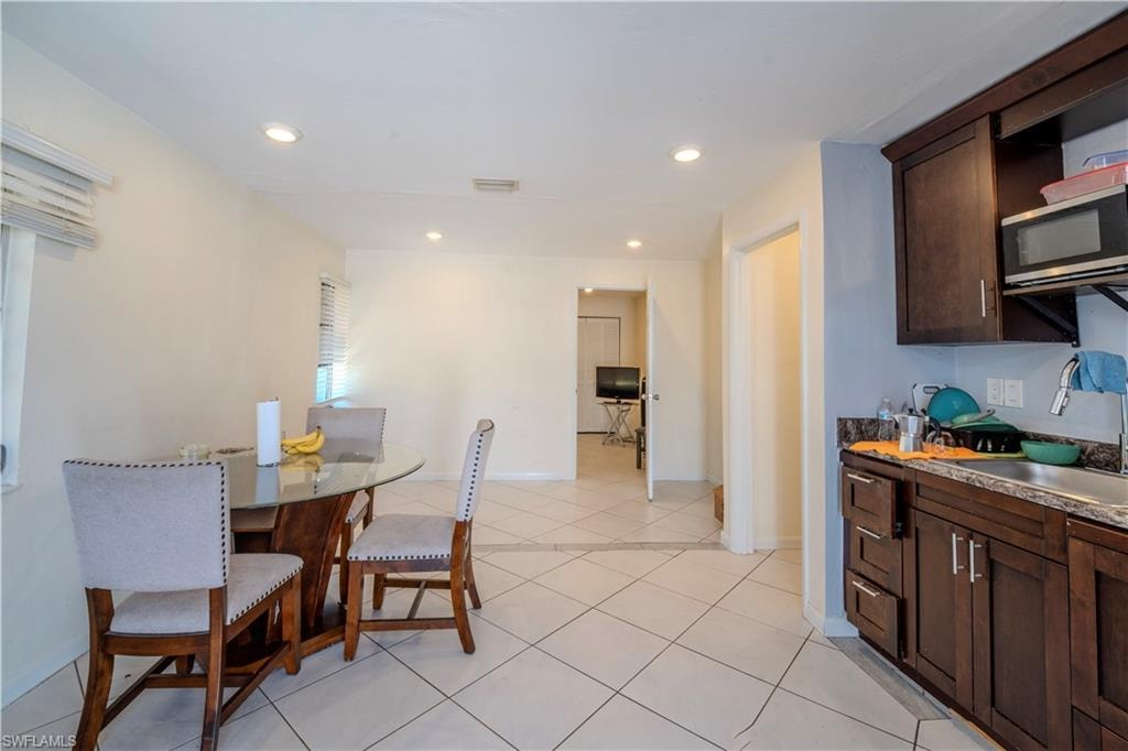 Integrated kitchen and dining area featuring recessed lighting