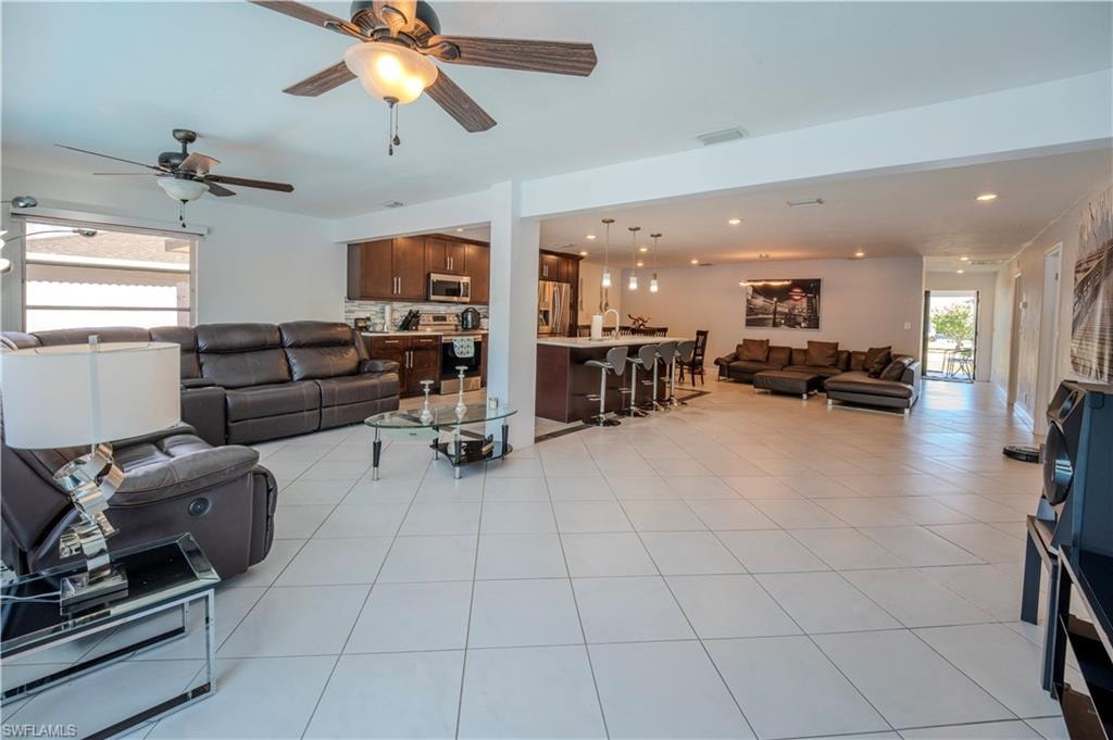 Spacious open-concept living area featuring large format tile flooring throughout