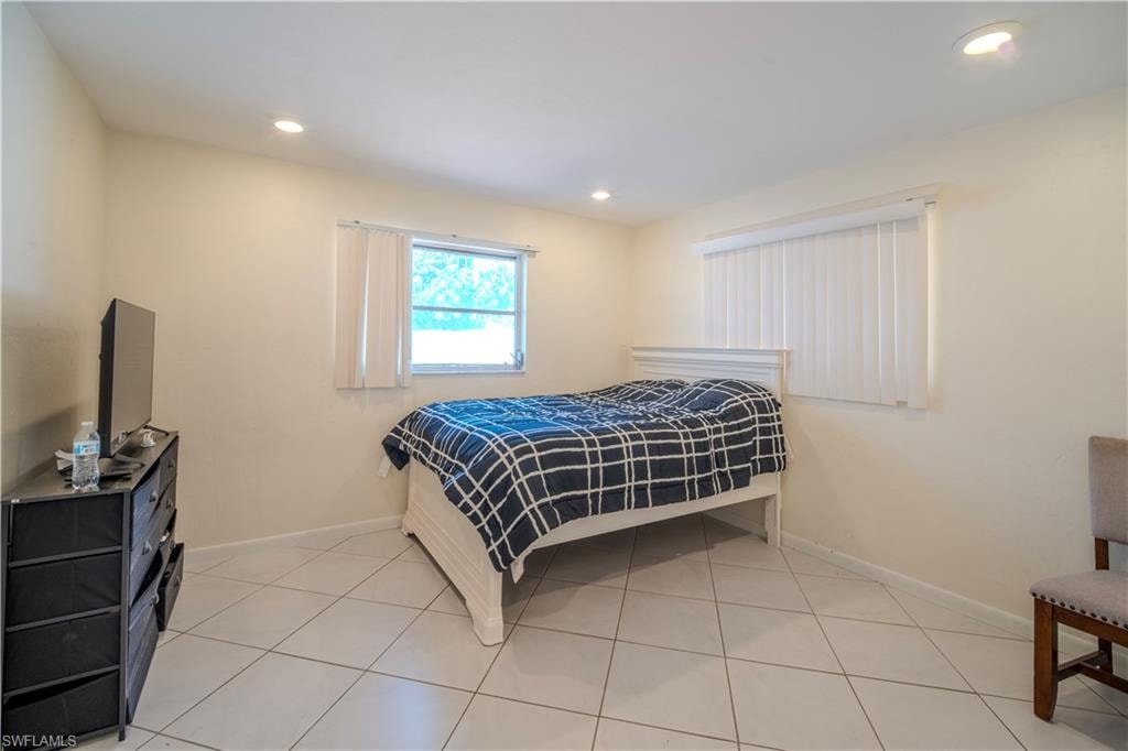 2nd Bedroom spacious room featuring light-colored walls and large format tile flooring
