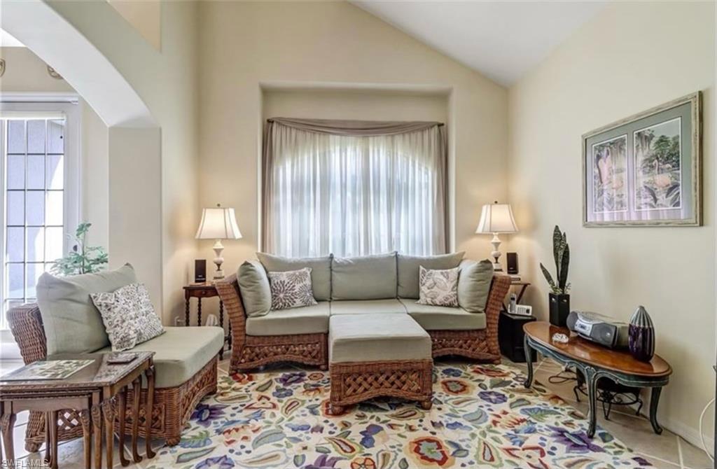 Sitting room featuring high vaulted ceiling and carpet floors