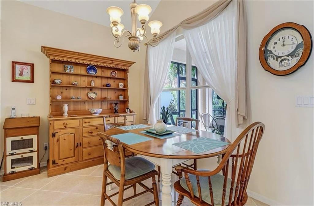 Tiled dining space featuring an inviting chandelier