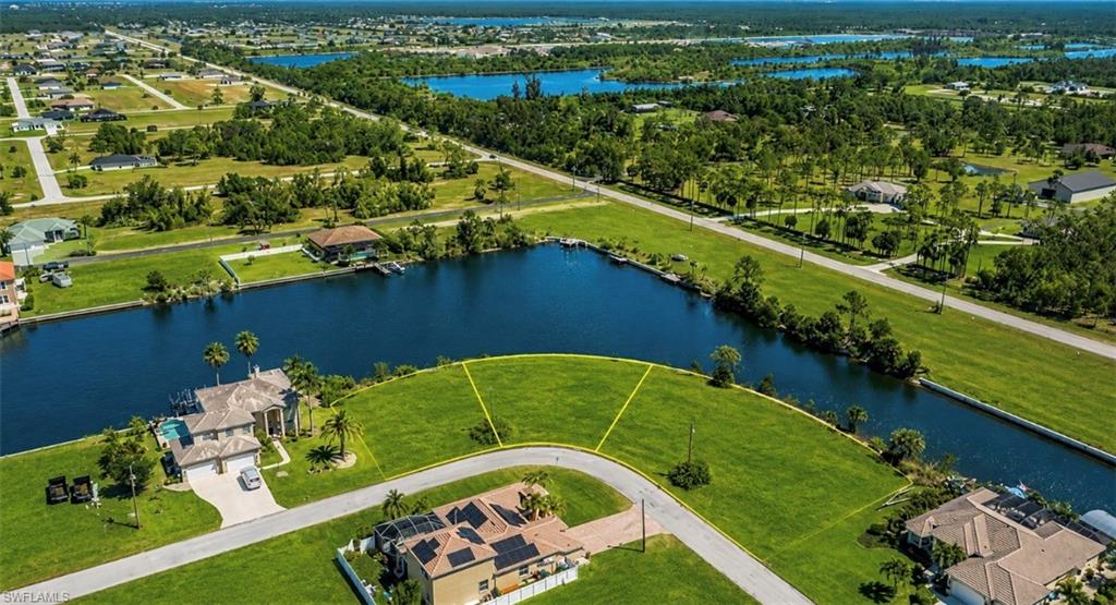 Expansive waterfront lots featuring direct canal access, lush green landscaping, and established residential surroundings