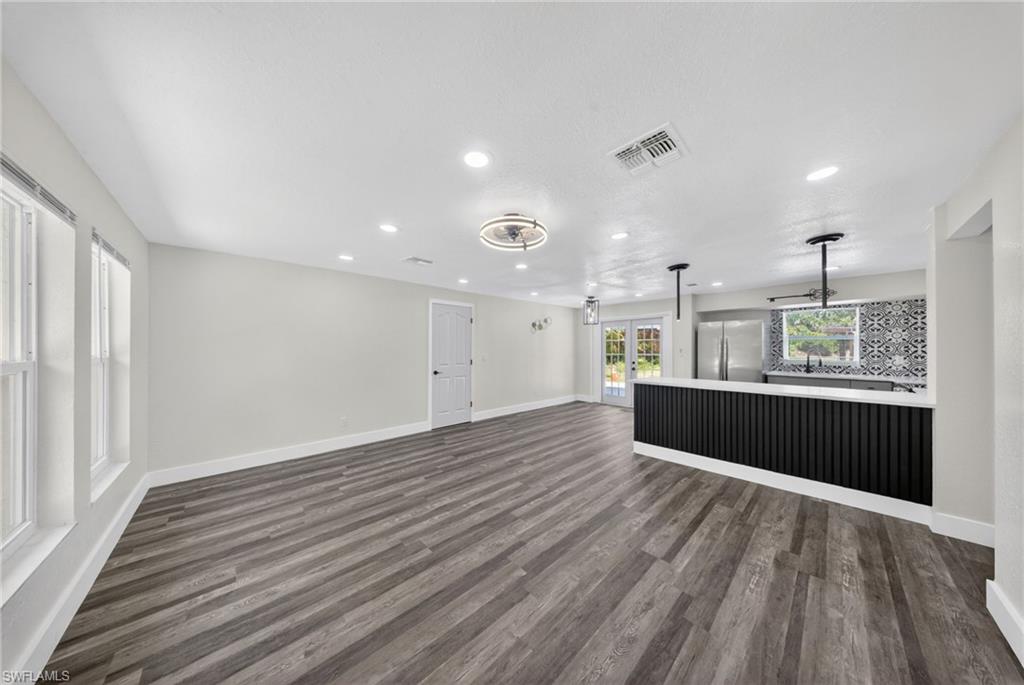 Spacious interior featuring wood-finish flooring, recessed lighting, and a contemporary ceiling fan