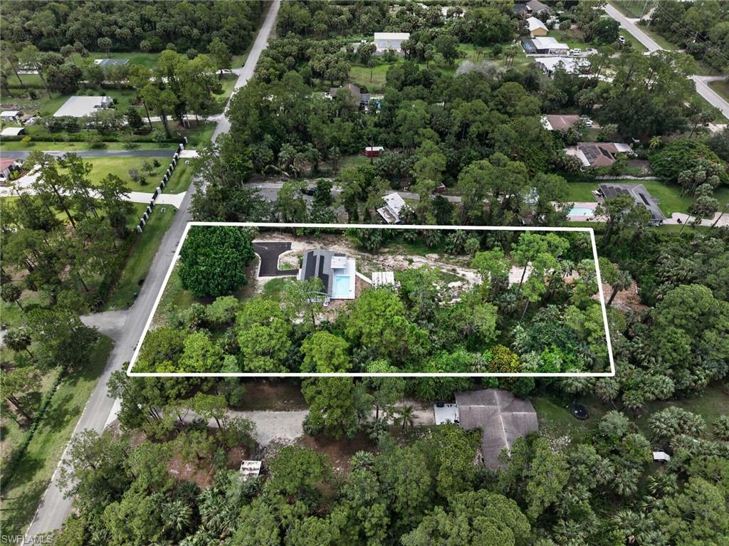 Aerial perspective highlighting a property with a distinct, modern-style residence