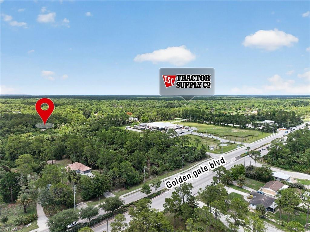 Aerial perspective highlighting a residential property surrounded by mature trees, situated near Golden Gate Blvd