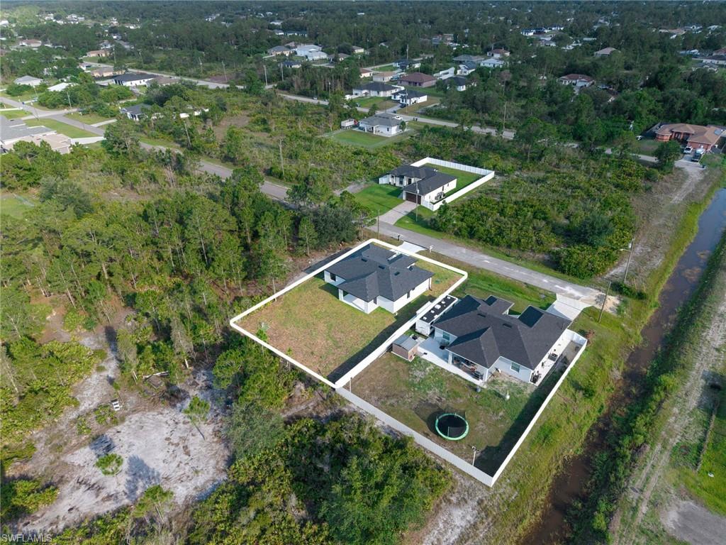Aerial perspective of a property with a distinct perimeter fence