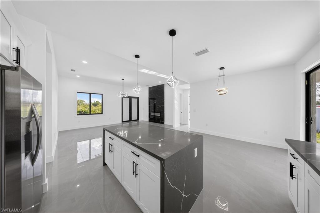 Open-concept interior featuring light gray tile flooring and white walls