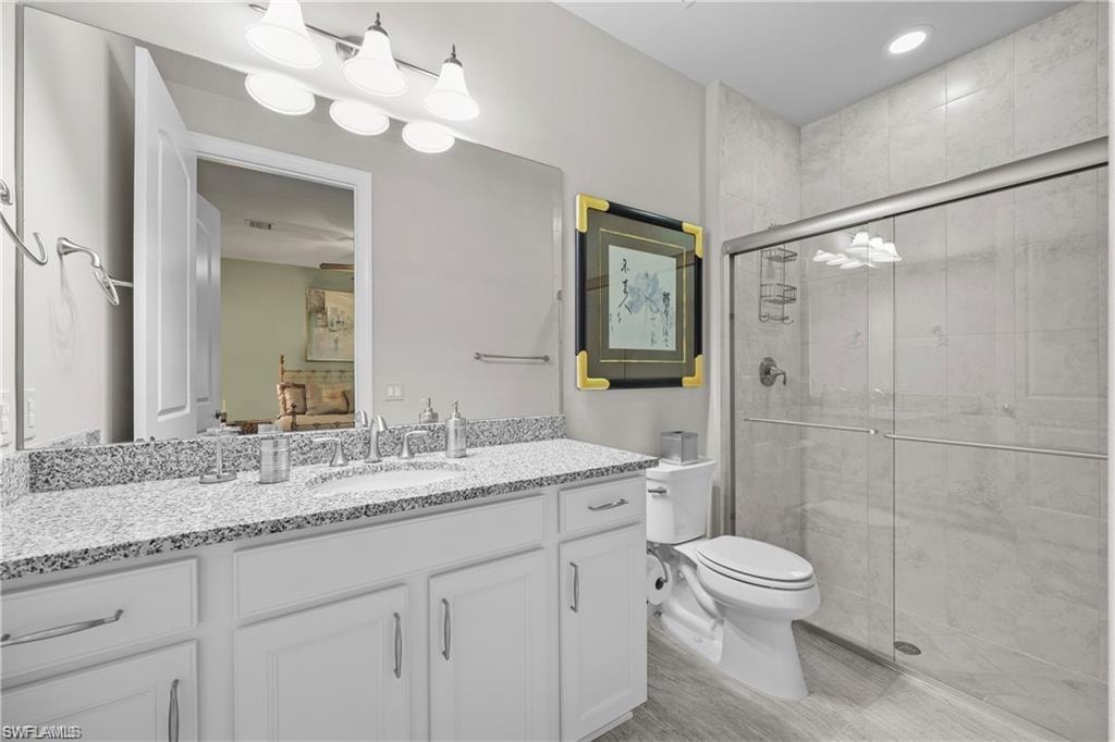 Bathroom featuring a shower stall and vanity