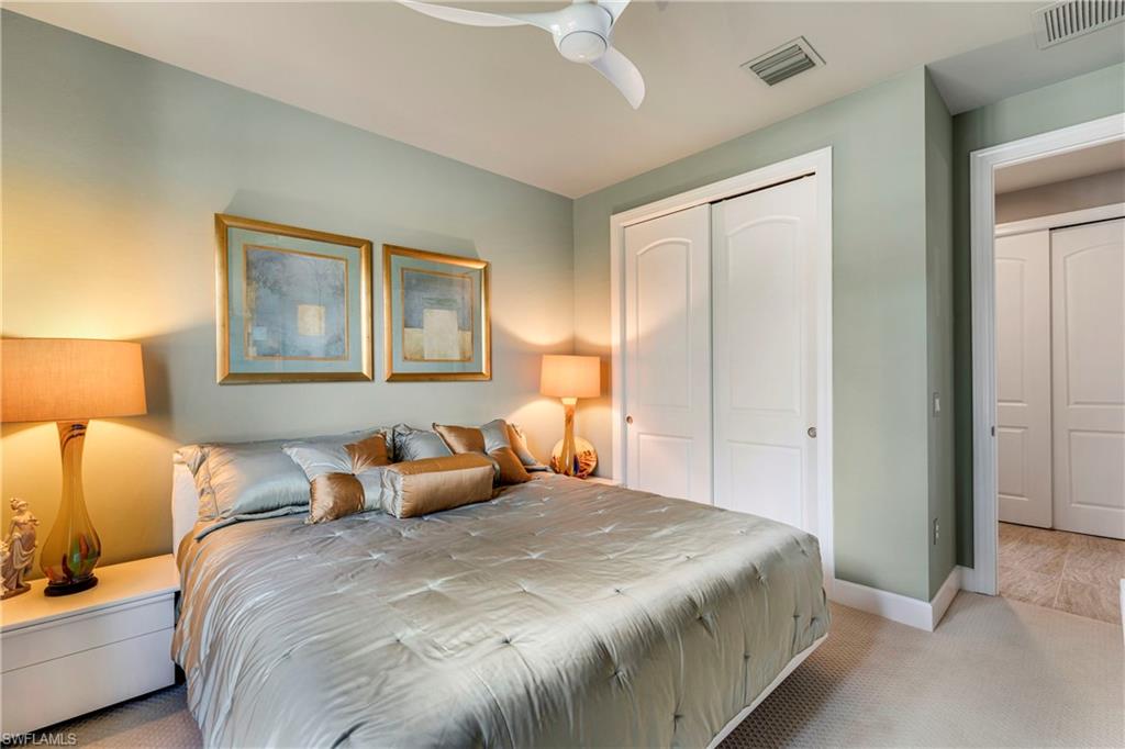 Bedroom featuring light carpet, a closet, visible vents, and baseboards