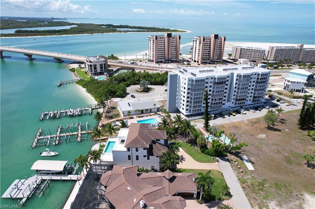 Waterfront property featuring private docks, a private boat lift, multiple residential buildings, and proximity to a bridge