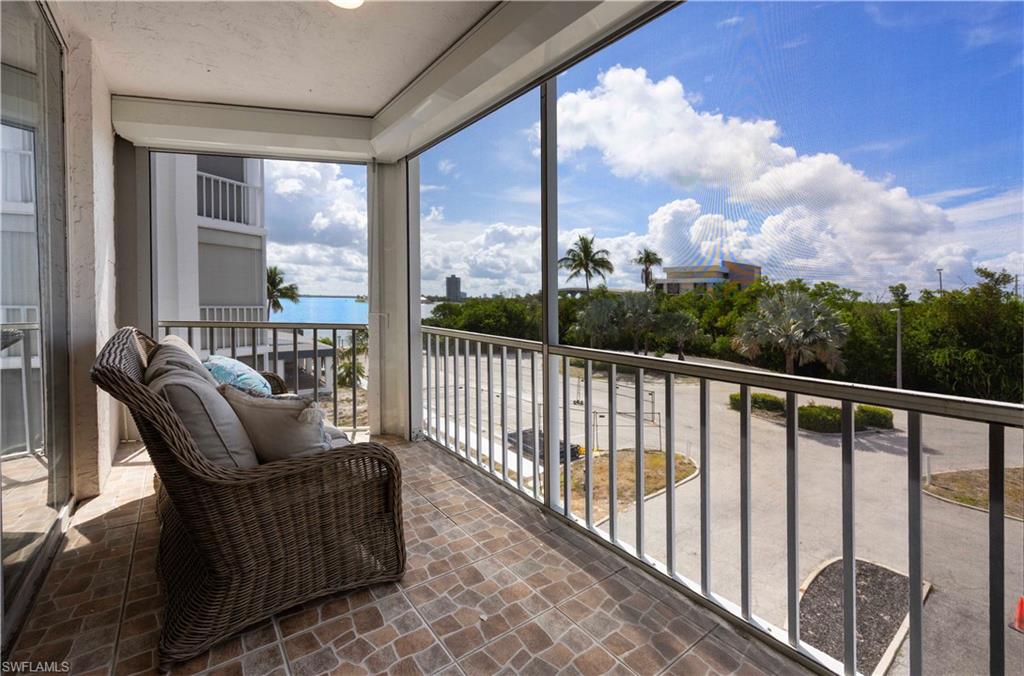 Screened balcony with geometric tile flooring, offering expansive outdoor living