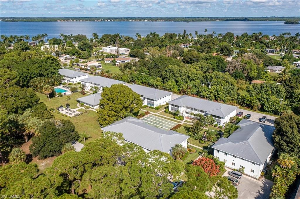 Expansive property featuring multiple two-story buildings with light exteriors and gray roofs