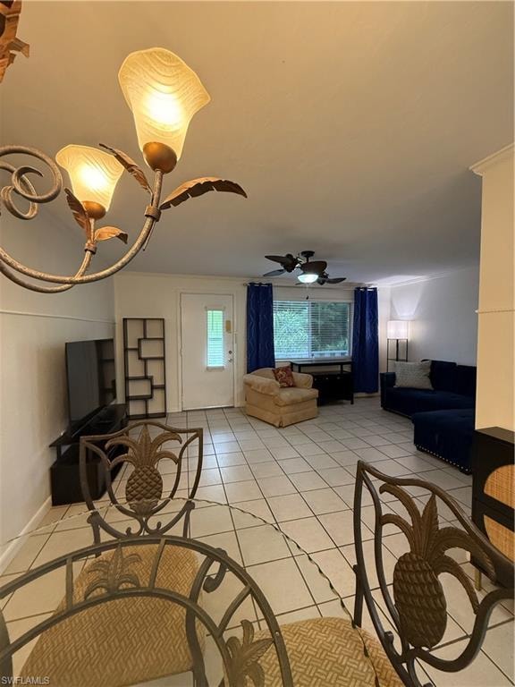 Open-concept living area featuring tile flooring, a ceiling fan, and a light-filled door with glass inserts