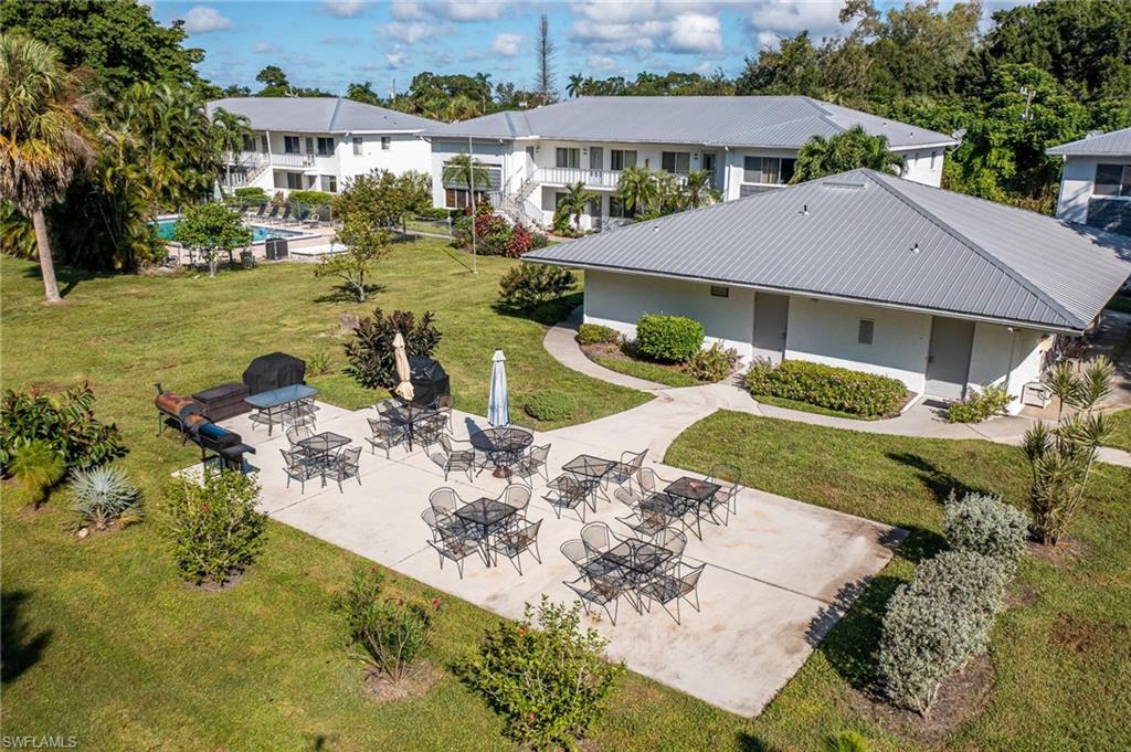 Central recreational patio with concrete pavers and surrounding green space