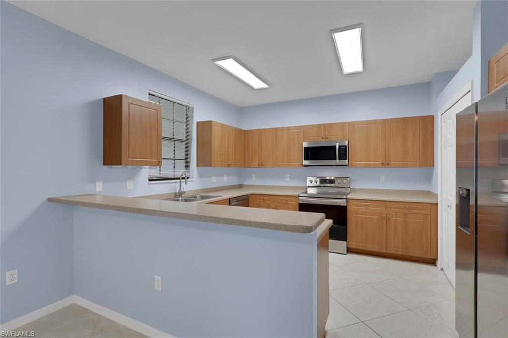 Stainless steel appliances including a refrigerator, range, and microwave