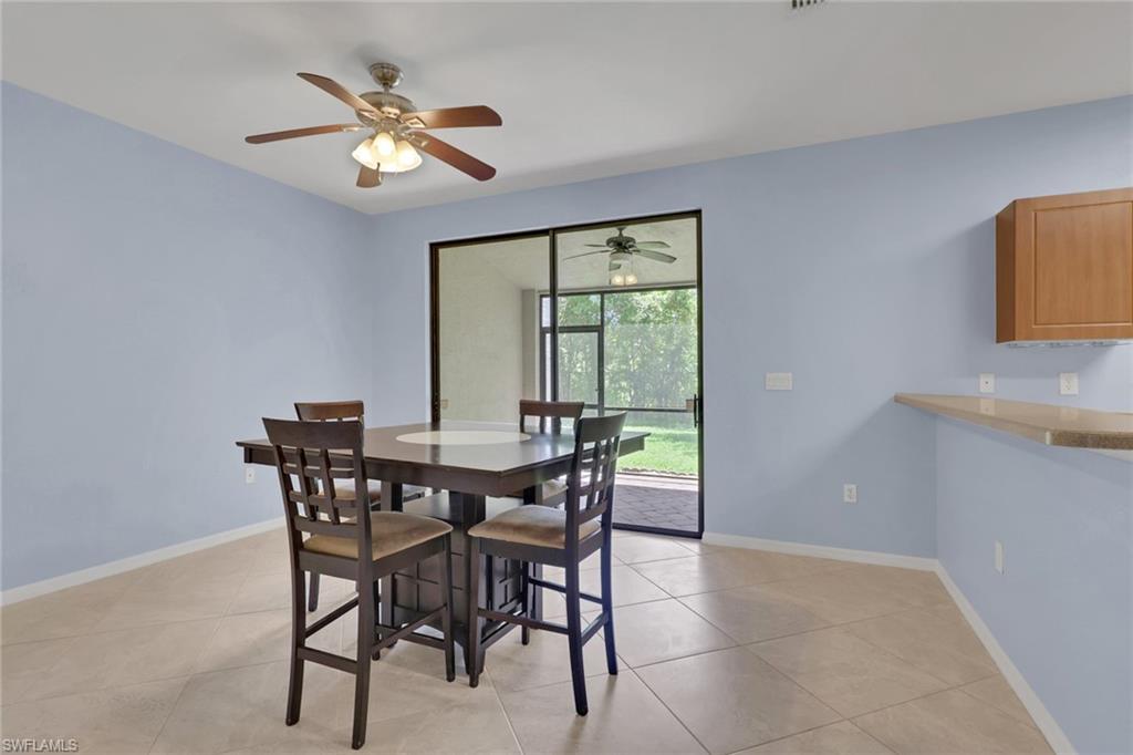 Dining area with light blue walls and large format tile flooring