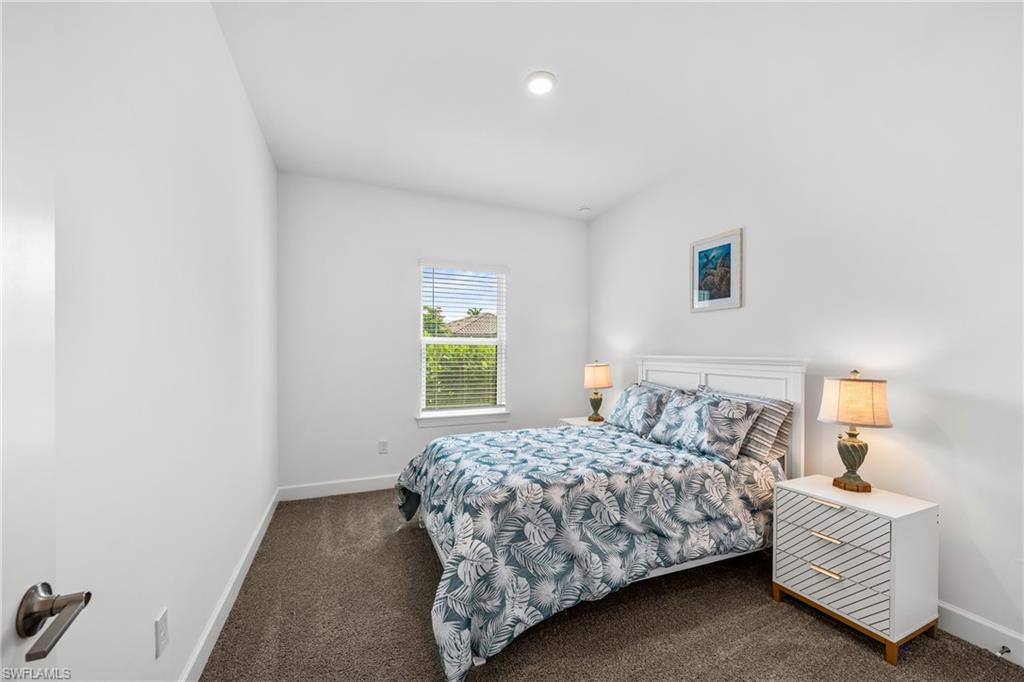 Bedroom featuring a single window with blinds, recessed ceiling lighting, and carpet flooring