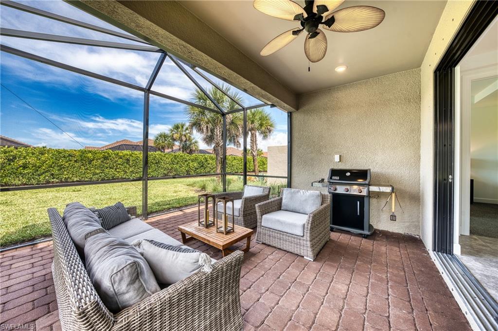Screened lanai featuring brick paver flooring, a ceiling fan, recessed lighting, and a sliding glass door entry