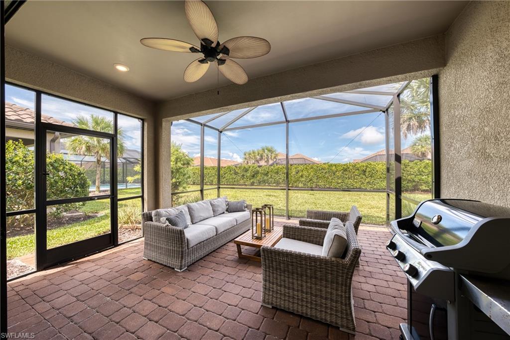 Screened lanai featuring paver flooring, a ceiling fan, and recessed lighting
