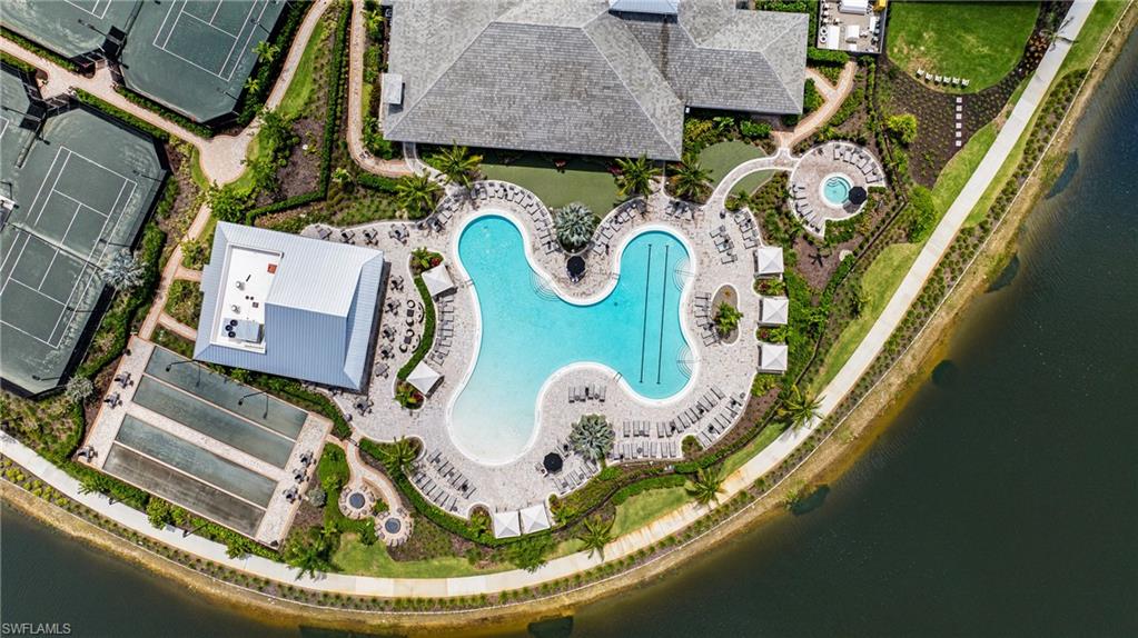 Expansive recreation area featuring a resort-style swimming pool, multiple tennis courts, bocce ball courts, and a spa area