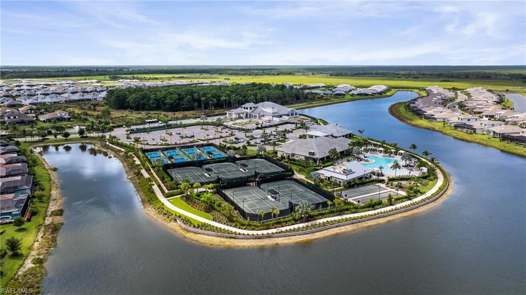 Waterfront community featuring multiple tennis courts, pickleball courts, and a resort-style swimming pool