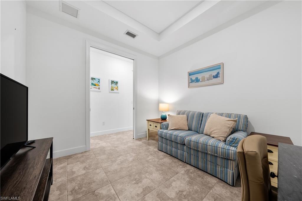 Neutral-toned large format tile flooring complements bright white walls