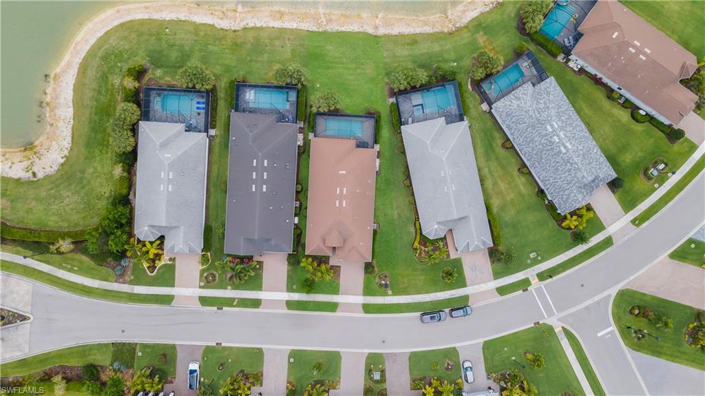 Aerial perspective showcasing properties with private pools, individual driveways, and manicured lawns