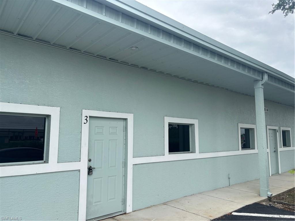 Stucco exterior with a light blue finish and white trim