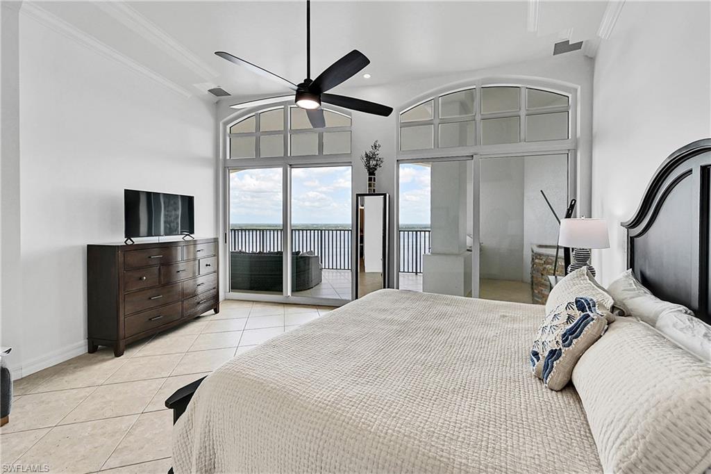 Bedroom featuring access to outside, light tile patterned floors, ornamental molding, baseboards, and a ceiling fan