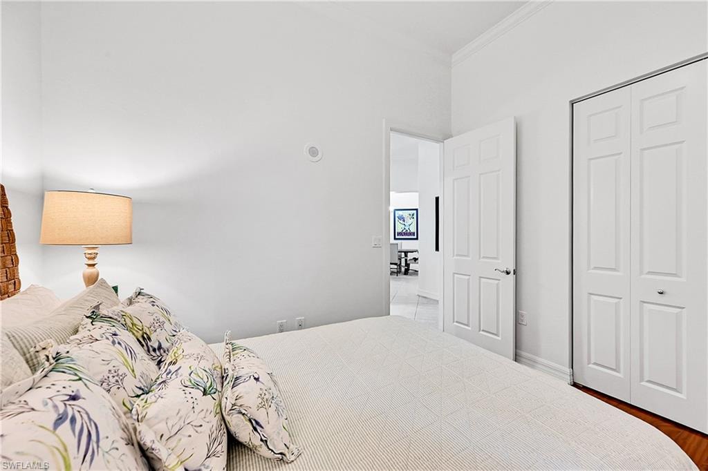 Bedroom featuring crown molding and a closet