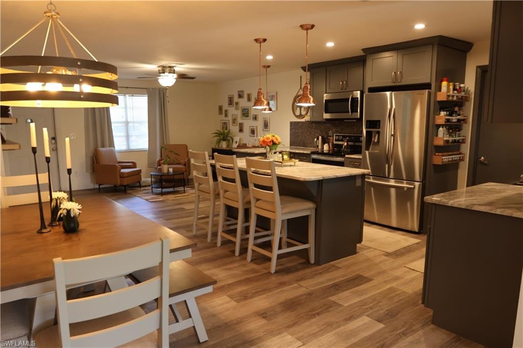 Open-concept living space featuring wood-finish flooring