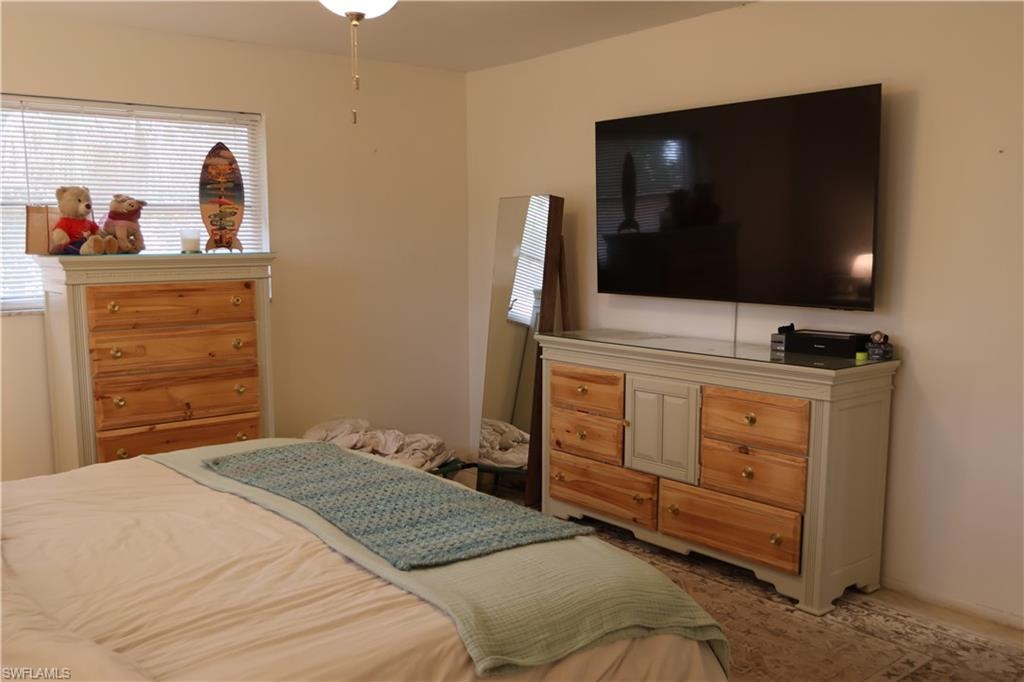 Room featuring neutral wall tones and a window with horizontal blinds