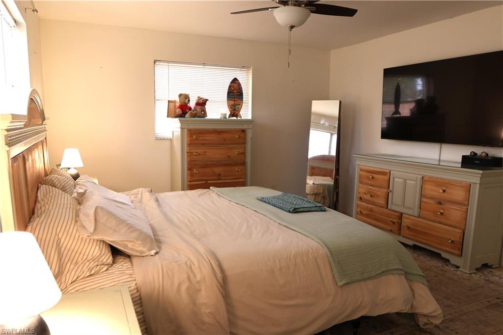 Room featuring a ceiling fan, window with blinds, and light-toned walls