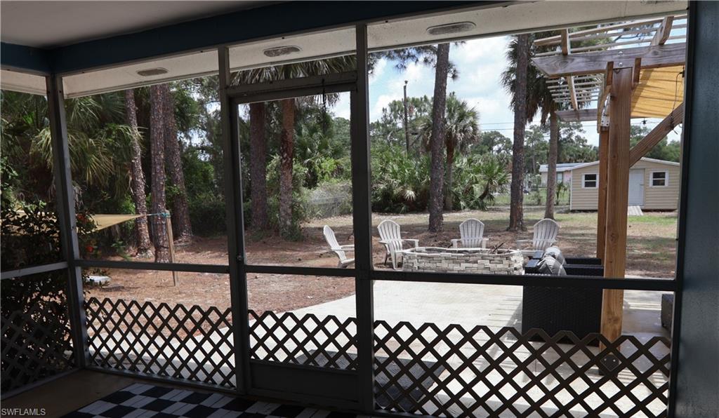 Screened porch with lattice accent panels and direct access to the backyard